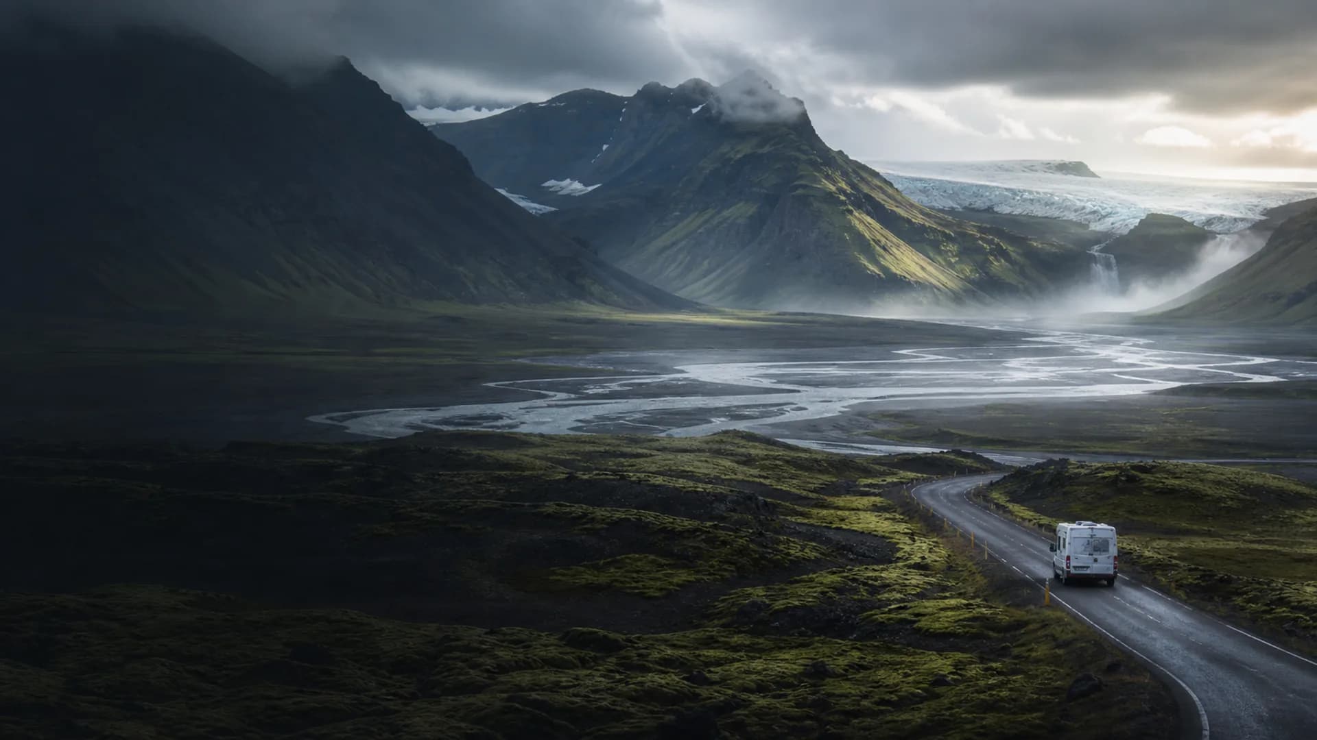 Campervan driving into a glacial valley on Iceland's Ring Road — illustrative image